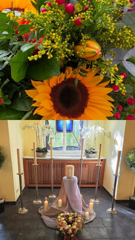 Blumenschmuck mit Sonnenblume und eine Urne auf einem Podest mit Kerzen